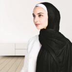A woman wearing a draped ribbed jersey hijab. Modify.pk