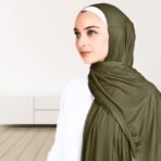 A woman wearing a draped ribbed jersey hijab. Modify.pk