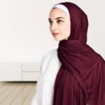 A woman wearing a draped ribbed jersey hijab. Modify.pk