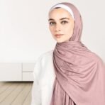 A woman wearing a draped ribbed jersey hijab. Modify.pk