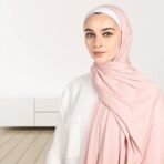 A woman wearing a draped ribbed jersey hijab. Modify.pk