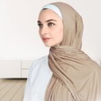 A woman wearing a draped ribbed jersey hijab. Modify.pk