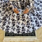 A woman using a Winter Namaz Chadar, performing namaz. Modify.pk