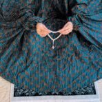 A woman using a Winter Namaz Chadar, performing namaz. Modify.pk