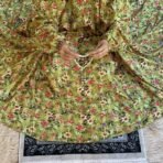 A woman using a Winter Namaz Chadar, performing namaz. Modify.pk